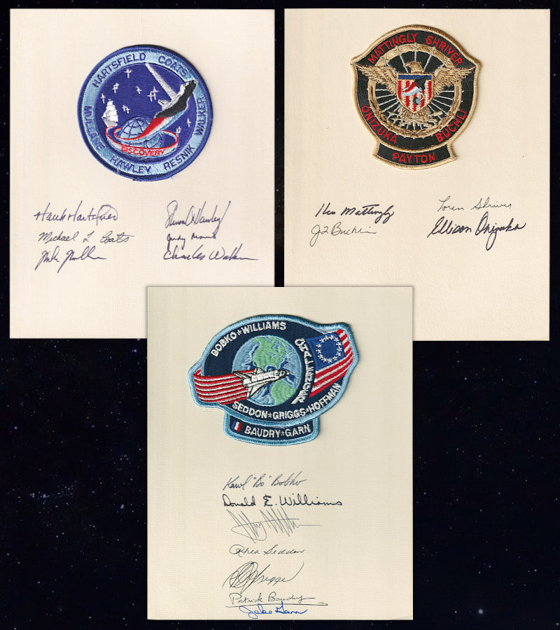 A collection of Space Shuttle patches and crew autographs